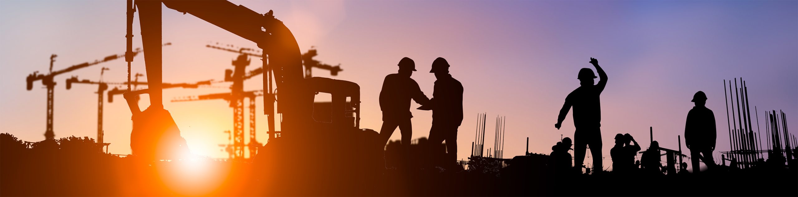 Construction workers at sunrise